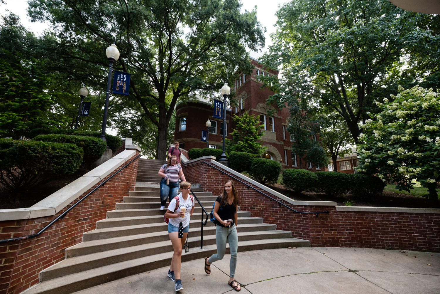 Students walk down the stairs toward the Rickey Science enterance