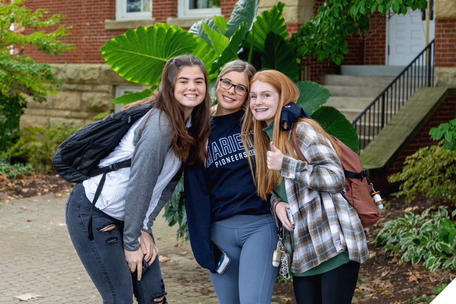 Three Marietta College students pose for a photo outside of Andrews Hall