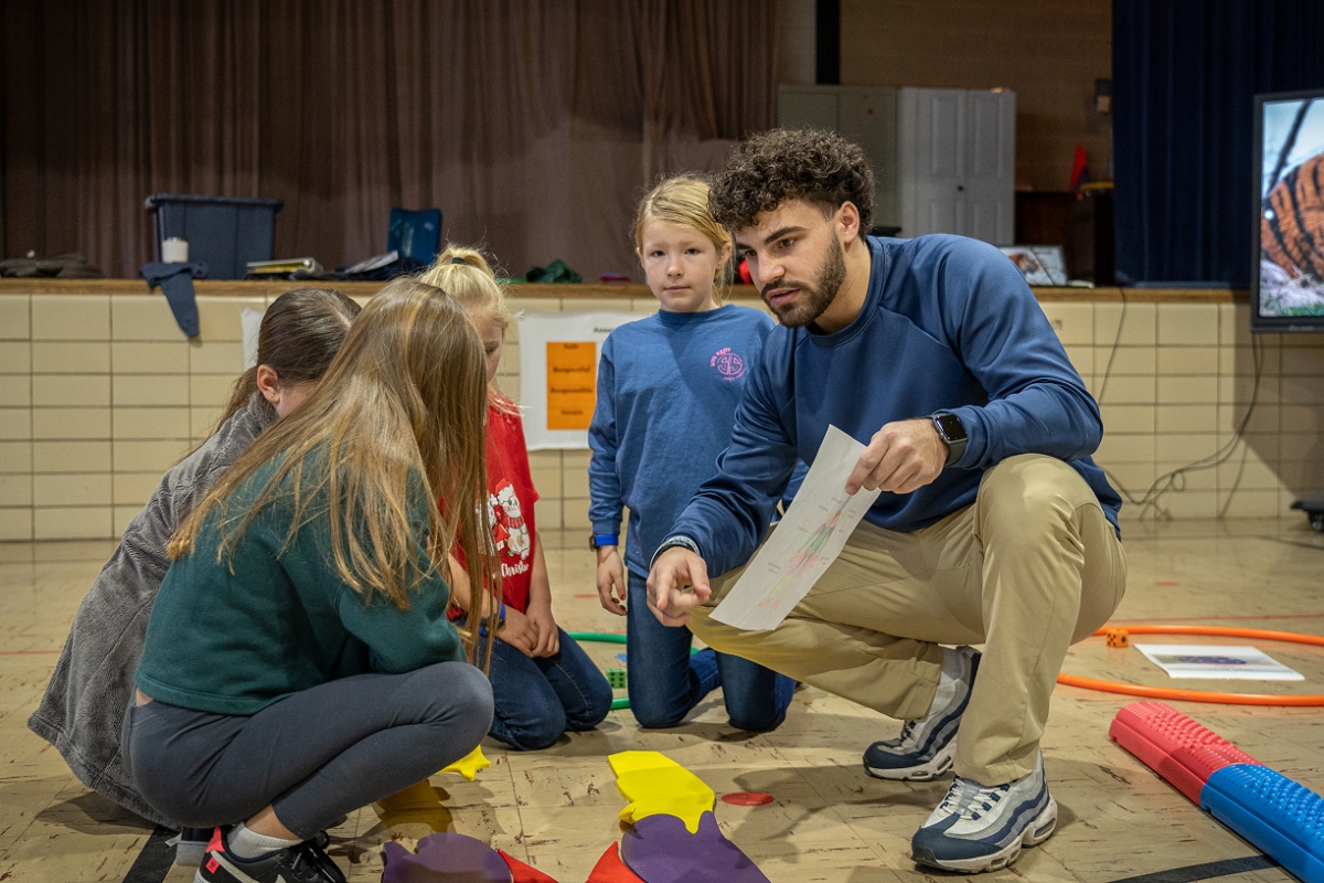 Student teachers interact with kids