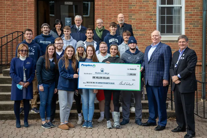 Students with faculty holding $1M check