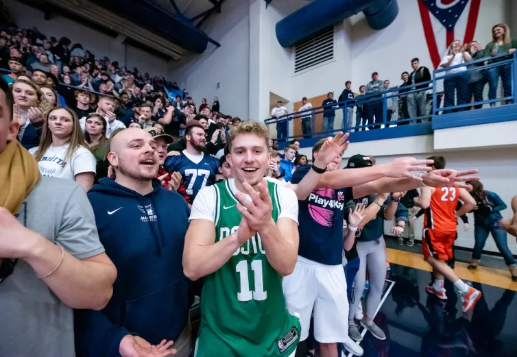 Marietta College students cheering on the men's basketball team in Ban Johnson Arena