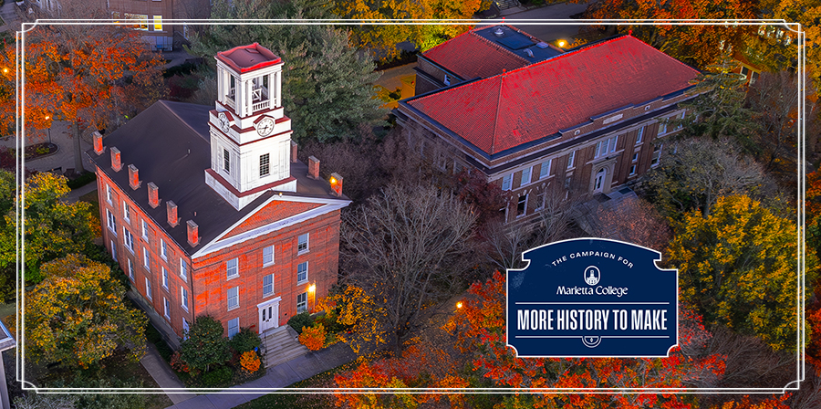 Historic brick building with clock tower on Marietta College campus in fall