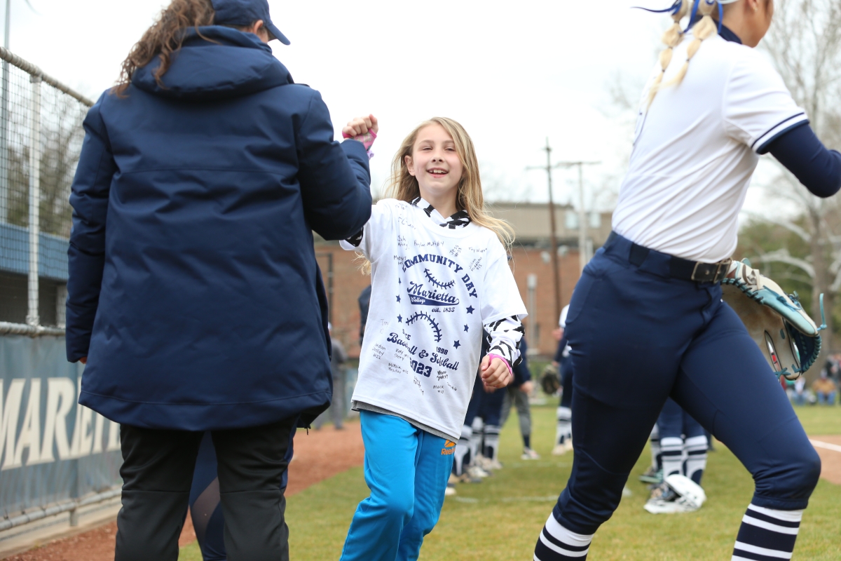 child attending Community Softball Day 