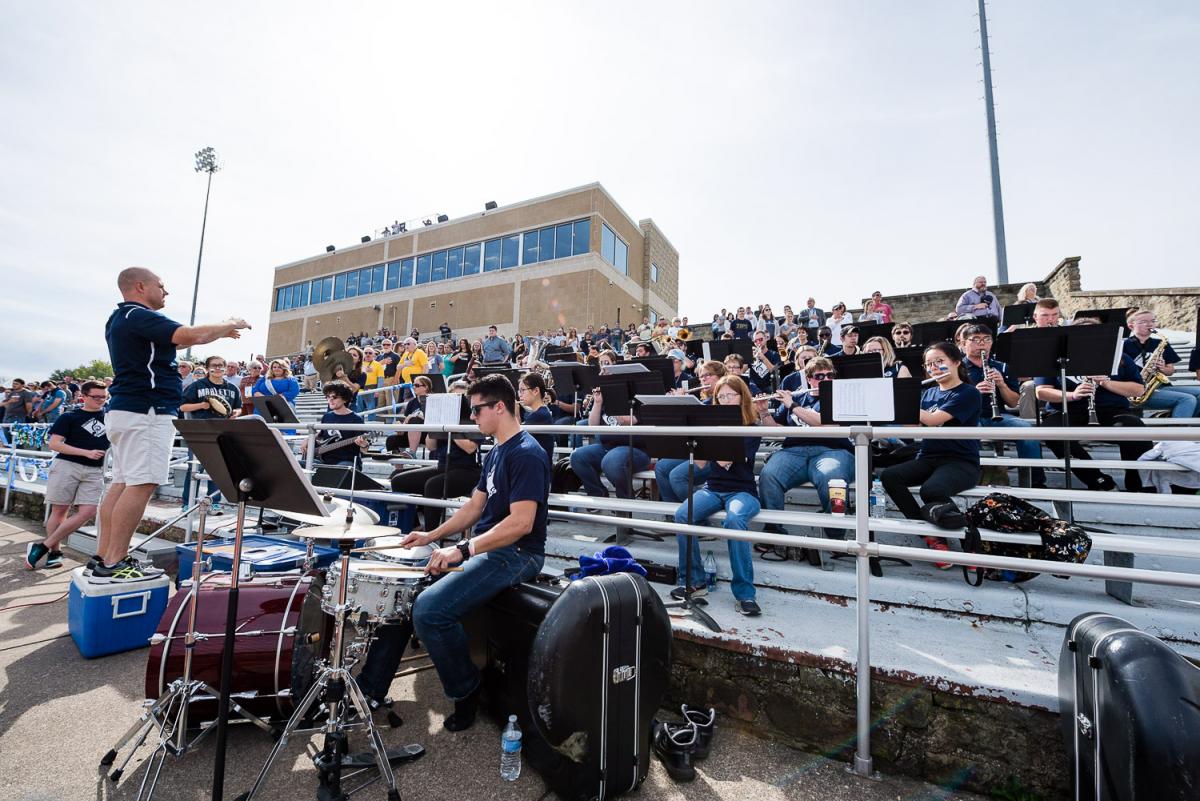 The Marietta Pep Band plays at a football game in Don Drumm Stadium