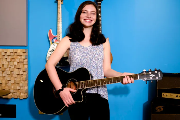 Lindsey McCoy playing a guitar