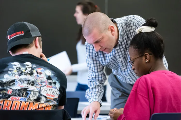 Dr. Kevin Pate helping students