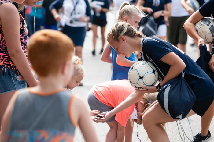 Soccer player handing out candy at the parade