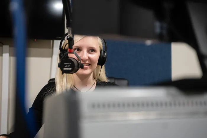 Hailey Lanham recording a podcast