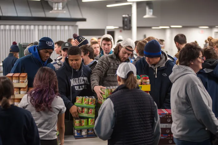 Students loading food into boxes