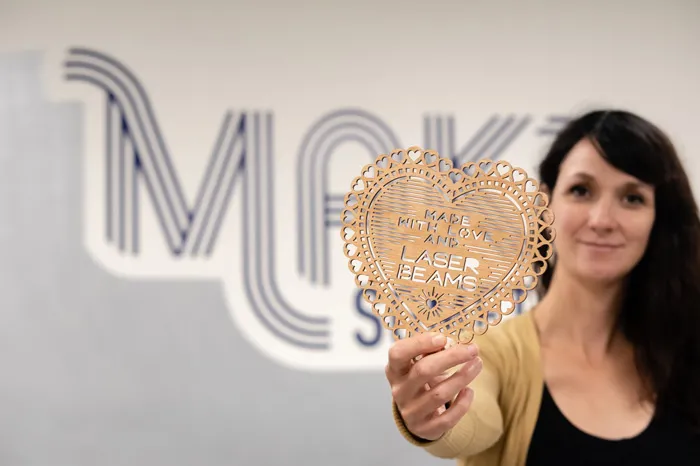 Sara Rosenstock holding an item created with a 3-D laser printer