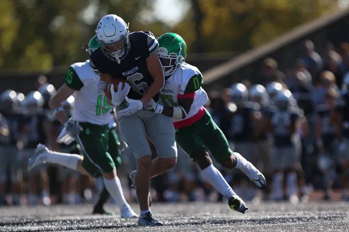 Marietta receiver being dragged down by a defender