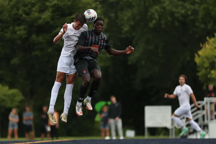 Marietta player heads the soccer ball