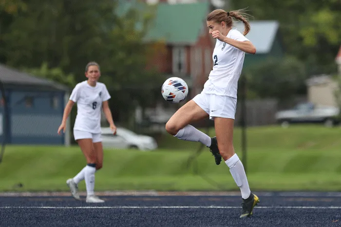 Player hitting the ball with her knee