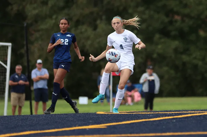 Player stopping the ball with her foot