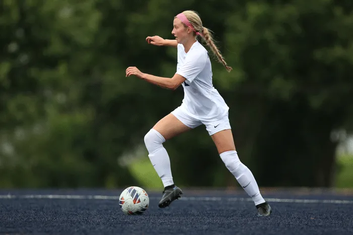 Soccer player dribbling the ball down field