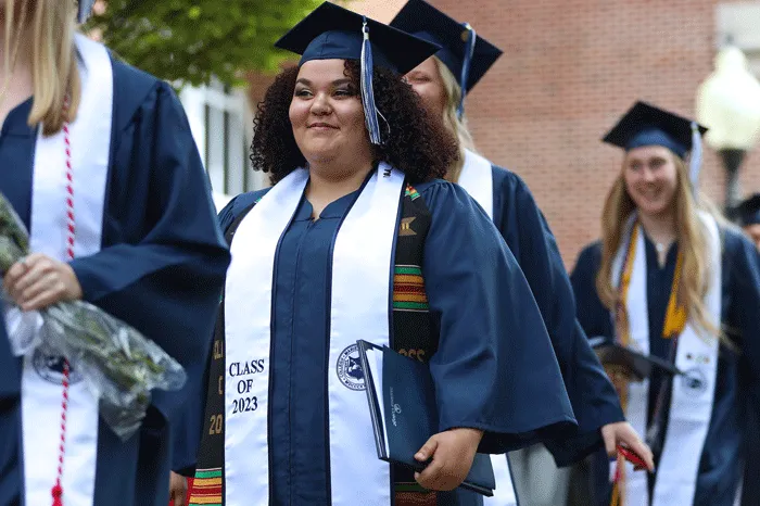 Graduate smiling following Commencement