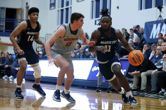 basketball player dribbling around a defender