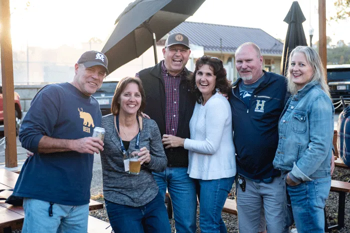 Alumni smiling outside