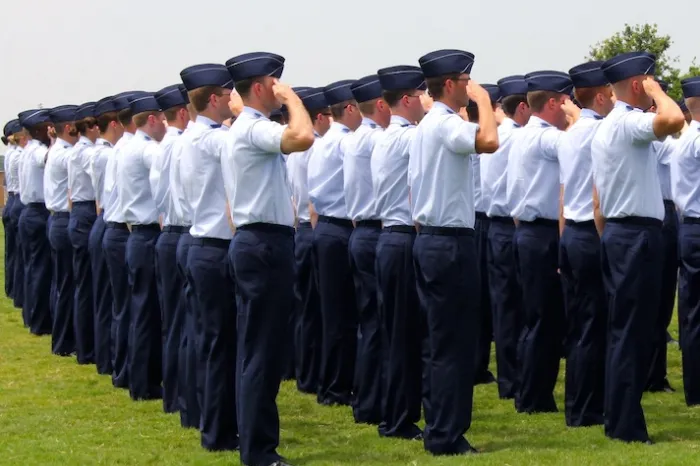 stock image of ROTC students saluting