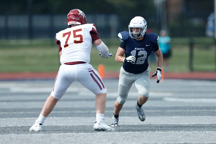 Defender working to get around a lineman