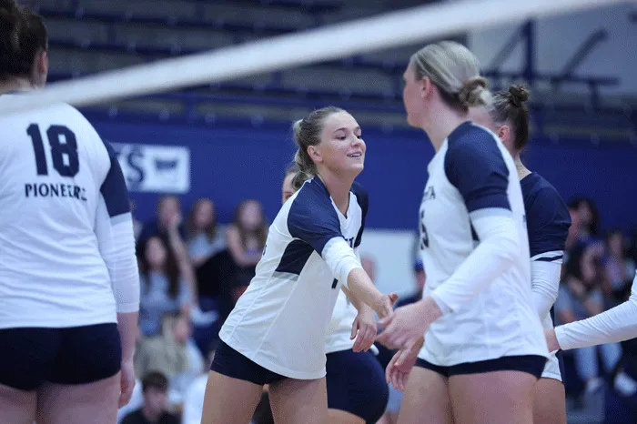 Volleyball players celebrating a point