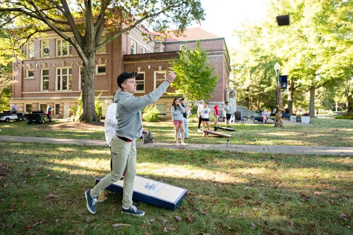 student playing cornhole