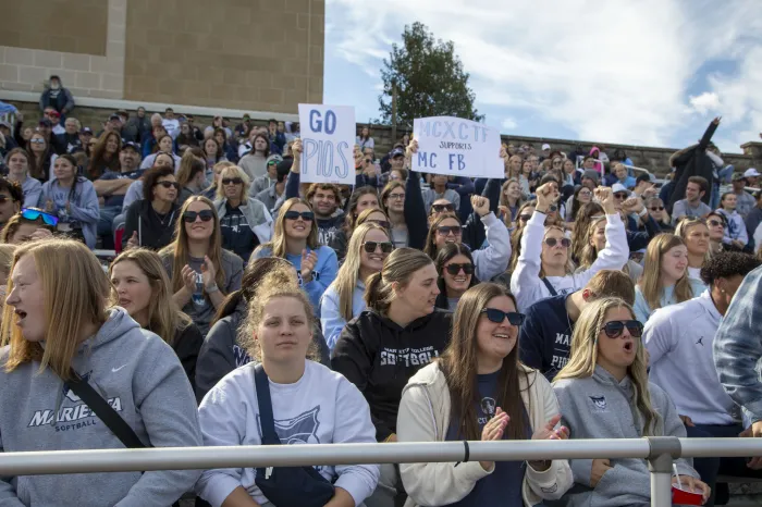 Students cheering on Marietta College's football team