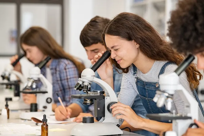 student using a microscope