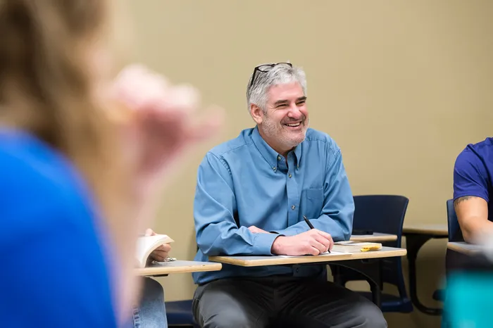 Professor Tim Catalano sitting in a classroom