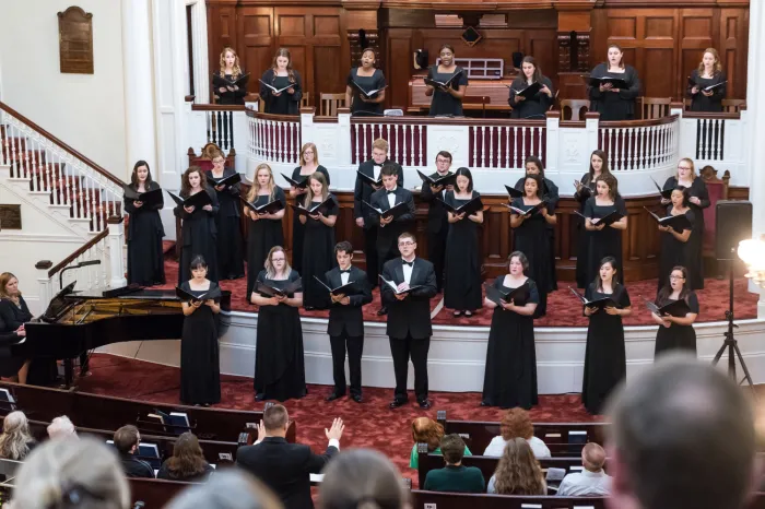 Choir members singing in a church