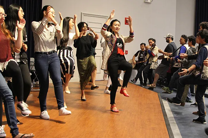 Students, employees and members of Manhu performing