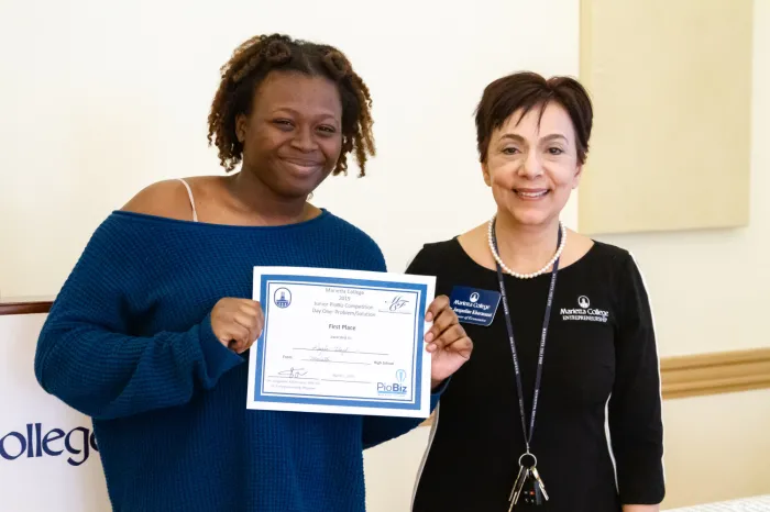 MHS' Kayla Floyd receives her certificate from Jackie Khorassani