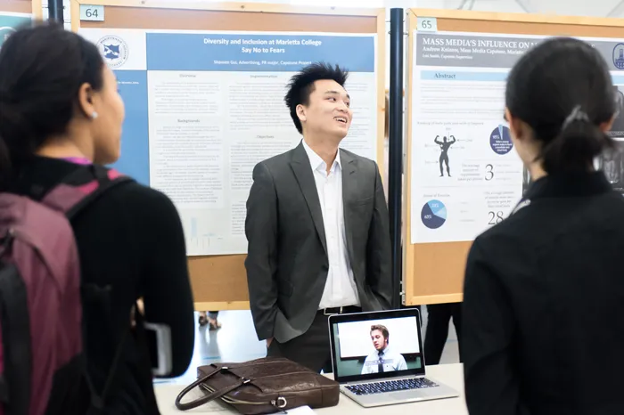 Male student making a presentation during All Scholars Day