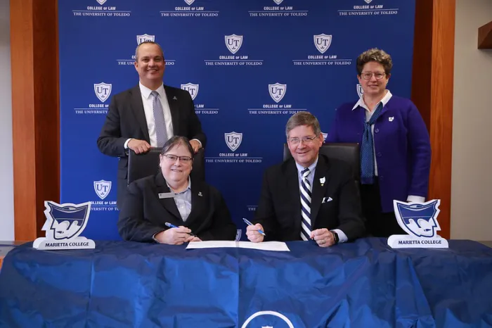 University administrators gathered for a form signing