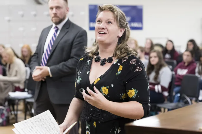 Amy Yekel singing to a class of students