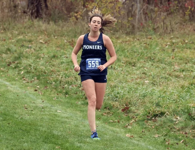 Competitor running alone in cross country race