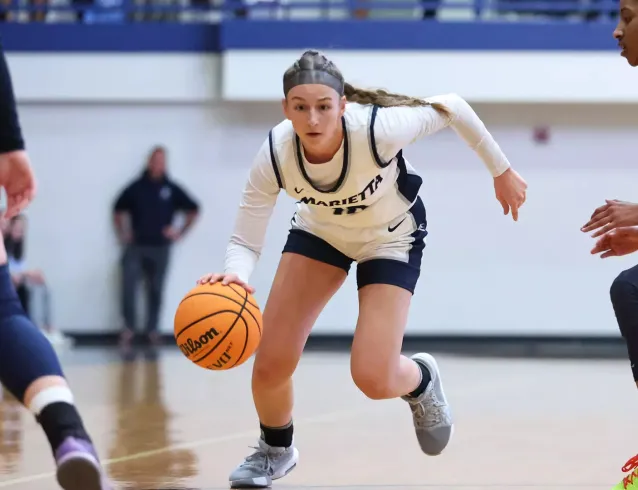 Adi Hill dribbling between two defenders