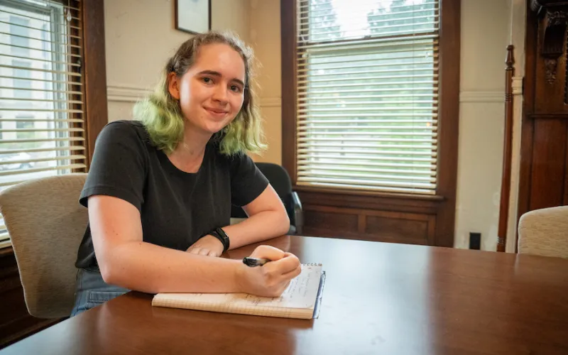 Lily Sorensen sits at a desk