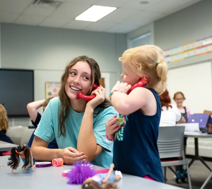 A Marietta College Education major works with an elementary school child