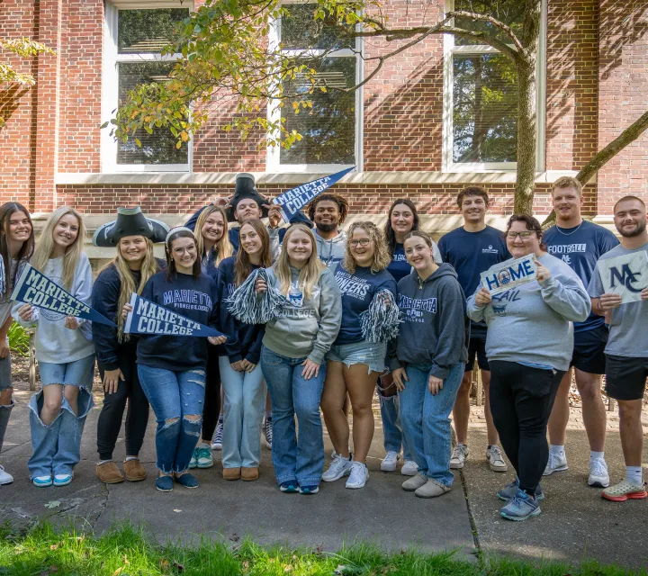 Students holding up Marietta College banners