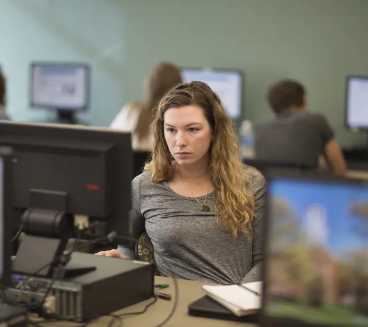 Marietta College student at a computer in a classroom