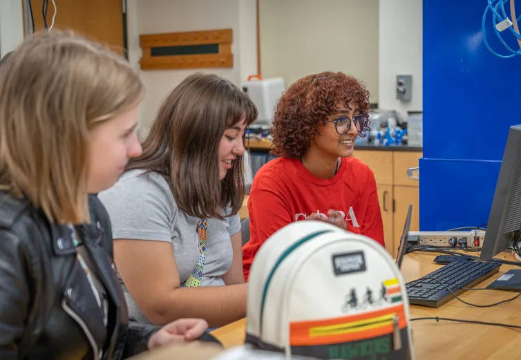 Three female students in a computer lab