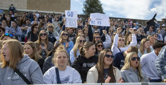 Students cheering on Marietta College's football team