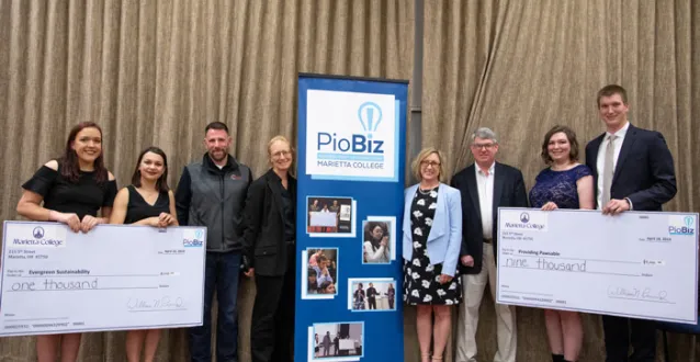 PioBiz winners posing with checks and the judges