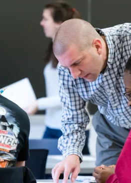 Professor Kevin Pate looks over course work with chemistry majors