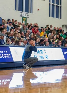 Men's basketball head coach Jon VanderWal shouts out instructions to his team during a game at Ban Johnson Arena