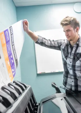 A Marietta College Organizational Communication and Public Relations major prints a poster in the Communications Resource Center