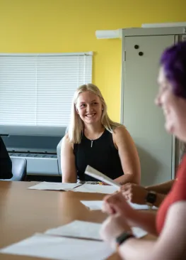 Students in the Marietta College Master of Arts in Psychology (MAP) Program sit around a table during a discussion with a professor.