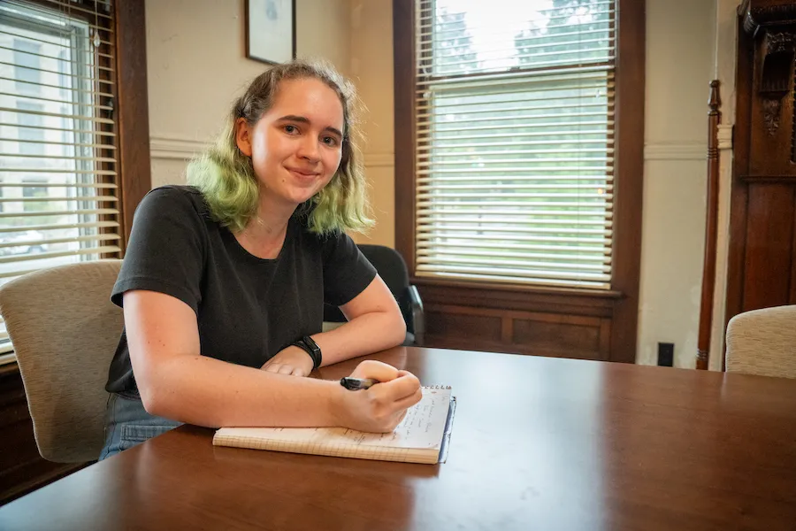 Lily Sorensen sits at a desk